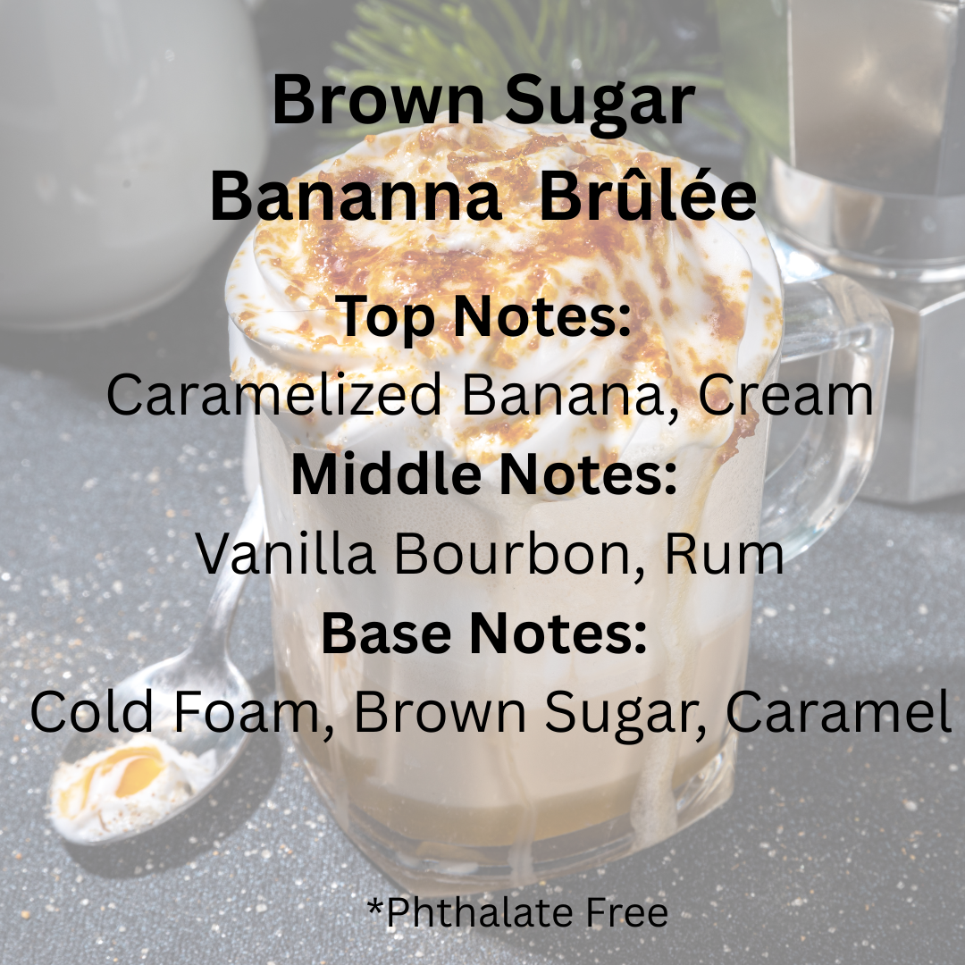 A glass mug filled with a whipped cream and caramel-topped beverage sits on a countertop with overlaid scent notes reading 'Brown Sugar Bananna Brûlée' and fragrance notes. The background is softly blurred, with a spoon and metallic object visible.