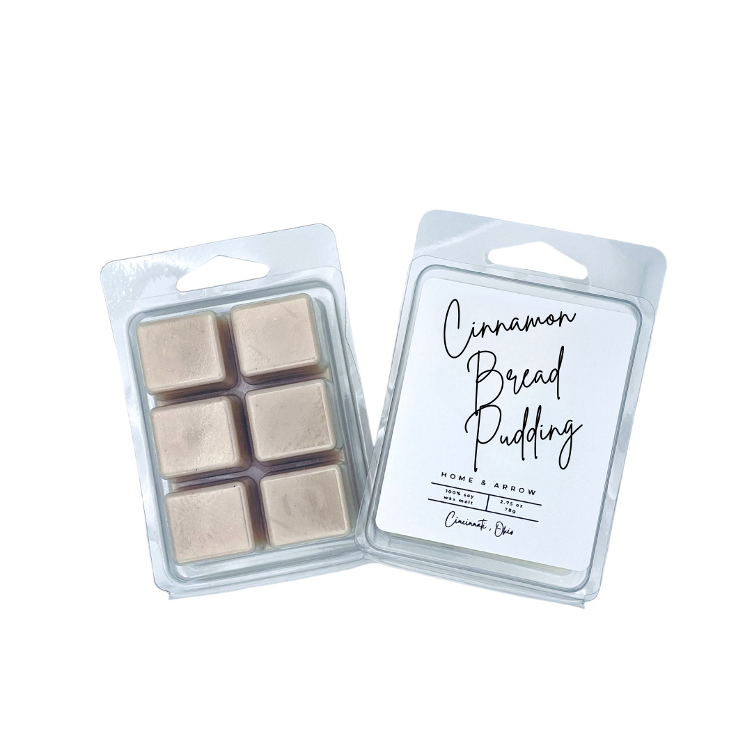 Two clear plastic wax melts packages on a white background. One package shows six beige wax cubes, and the other shows the front label reading 'Cinnamon Bread Pudding' with scent details.