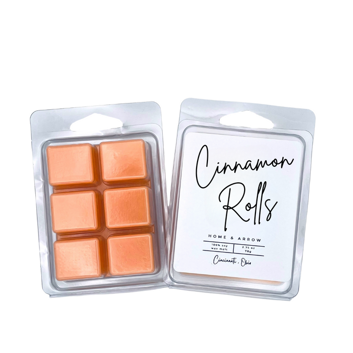 Cinnamon Rolls orange soy wax melts in clamshell packaging on a white backround from Home & Arrow based in Cininnati, Ohio. 